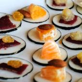 Black radish sliced and topped with healthy canapés appetizers